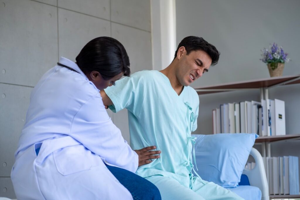 Patient performing spine surgery recovery exercises with physical therapist guidance