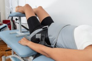 Woman receiving spinal decompression therapy while laying on a table.
